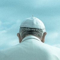 The back of Pope Francis' head as he wears a white cap.