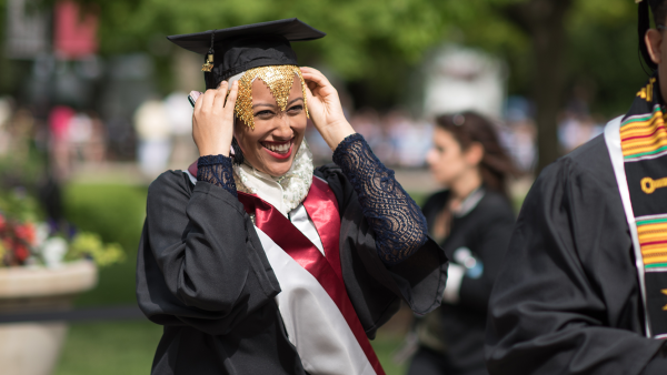 UChicago student at outside convocation in academic regalia