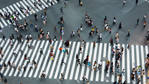 Bustling crowd of pedestrians on walkway in Tokyo, Japan.
