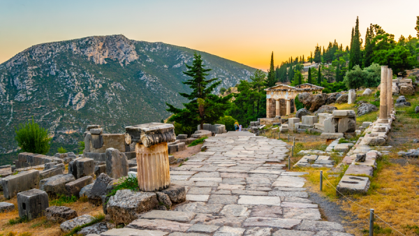 Sunset view of Athenian treasury at the ancient Delphi site in Greece.